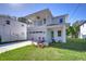Two-story house with balcony, attached garage, and landscaped lawn at 515 Elm St, Safety Harbor, FL 34695
