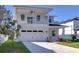 Two-story house with balcony, attached garage, and landscaped lawn at 515 Elm St, Safety Harbor, FL 34695