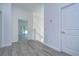 White hallway with wood-look floors and doors to other rooms at 515 Elm St, Safety Harbor, FL 34695