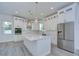 Modern kitchen with white cabinets, large island, and stainless steel appliances at 515 Elm St, Safety Harbor, FL 34695