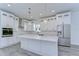 Modern kitchen with white cabinets, large island, and stainless steel appliances at 515 Elm St, Safety Harbor, FL 34695