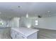Open concept kitchen with island, white cabinets, and spacious layout at 515 Elm St, Safety Harbor, FL 34695