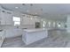 Open concept kitchen and living area with white cabinets and hardwood floors at 515 Elm St, Safety Harbor, FL 34695