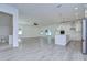 Open concept kitchen and living space featuring white cabinets, an island, and hardwood floors at 515 Elm St, Safety Harbor, FL 34695