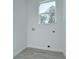 Small laundry room with white walls and a window at 515 Elm St, Safety Harbor, FL 34695