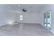Bright living room with grey flooring, sliding glass doors and a ceiling fan at 515 Elm St, Safety Harbor, FL 34695