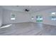 Bright and spacious living room with grey wood-look flooring and sliding glass doors at 515 Elm St, Safety Harbor, FL 34695