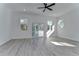 Spacious main bedroom with wood-look floors, ceiling fan, and sliding glass doors to balcony at 515 Elm St, Safety Harbor, FL 34695