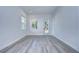 Bright and airy spare bedroom with grey wood-look floors and exterior access at 515 Elm St, Safety Harbor, FL 34695
