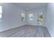 Bright and airy spare bedroom with grey wood-look floors and exterior access at 515 Elm St, Safety Harbor, FL 34695