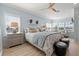 Spacious bedroom with light blue walls, a comfy bed, and a sitting area at 6125 Moorings S Dr, St Petersburg, FL 33712