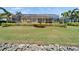 Beautiful backyard featuring a screened lanai with waterfront views and meticulous landscaping for serene outdoor enjoyment at 721 Manns Harbor Dr, Apollo Beach, FL 33572