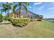 Spacious yard features a screened lanai, waterfront views and lush tropical landscaping for an outdoor paradise at 721 Manns Harbor Dr, Apollo Beach, FL 33572