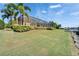 Expansive backyard with waterfront views, a screened lanai, and lush landscaping, creating a private outdoor oasis at 721 Manns Harbor Dr, Apollo Beach, FL 33572