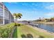 Lush lawn beside a canal, offering a tranquil waterfront view at 721 Manns Harbor Dr, Apollo Beach, FL 33572