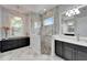 Bathroom showcases a frameless glass shower, marble floors and countertops at 721 Manns Harbor Dr, Apollo Beach, FL 33572