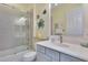 Bathroom with a walk-in shower, white vanity, and coastal decor at 721 Manns Harbor Dr, Apollo Beach, FL 33572