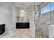 Stunning bathroom with decorative light fixture and marble shower at 721 Manns Harbor Dr, Apollo Beach, FL 33572