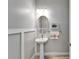 Powder room featuring a pedestal sink, decorative mirror, and gray walls at 721 Manns Harbor Dr, Apollo Beach, FL 33572