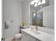 Bathroom vanity with decorative mirror, sink, and shower with neutral tile at 721 Manns Harbor Dr, Apollo Beach, FL 33572