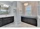 Elegant bathroom features dark vanity, marble floors, and a window seat at 721 Manns Harbor Dr, Apollo Beach, FL 33572