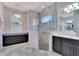 Spa-like bathroom with walk-in shower, double vanity, and marble floors at 721 Manns Harbor Dr, Apollo Beach, FL 33572