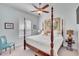 Main bedroom with a large four-poster bed and beach themed art at 721 Manns Harbor Dr, Apollo Beach, FL 33572