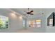 Bedroom with ceiling fan, tray ceiling, plantation shutters, and lots of natural light at 721 Manns Harbor Dr, Apollo Beach, FL 33572