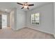 Bedroom with ceiling fan, window with shutters, closet, and neutral carpet at 721 Manns Harbor Dr, Apollo Beach, FL 33572