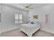 Inviting bedroom with a cozy bed, light-filled window, and ceiling fan at 721 Manns Harbor Dr, Apollo Beach, FL 33572
