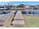 Wooden walkways leading to multiple boat lifts on a canal at 721 Manns Harbor Dr, Apollo Beach, FL 33572