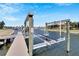 A large boat lift on a wooden dock by the canal at 721 Manns Harbor Dr, Apollo Beach, FL 33572