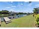 Green grass meets the canal with a dock at 721 Manns Harbor Dr, Apollo Beach, FL 33572