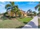 House exterior with landscaping, palm trees, and a sidewalk at 721 Manns Harbor Dr, Apollo Beach, FL 33572