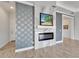 Living room featuring modern fireplace with decorative tile accent wall and crown moulding at 721 Manns Harbor Dr, Apollo Beach, FL 33572