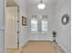 Bright foyer featuring double doors with decorative glass, wood-look tile, and neutral walls at 721 Manns Harbor Dr, Apollo Beach, FL 33572