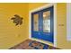 Inviting blue double front doors with decorative glass, a welcome mat, and a turtle ornament at 721 Manns Harbor Dr, Apollo Beach, FL 33572