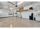 Spacious garage with epoxy flooring, overhead storage, water softener and storage cabinets at 721 Manns Harbor Dr, Apollo Beach, FL 33572