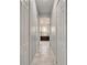 Hallway view with marble floors and doors leading to different rooms in the home at 721 Manns Harbor Dr, Apollo Beach, FL 33572