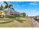 Back of house, screened lanai, and lush landscaping near canal at 721 Manns Harbor Dr, Apollo Beach, FL 33572