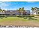 Back of the house with a screened enclosure and lush landscaping at 721 Manns Harbor Dr, Apollo Beach, FL 33572