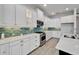 Well-equipped kitchen with white cabinets, a backsplash, and stainless steel appliances at 721 Manns Harbor Dr, Apollo Beach, FL 33572