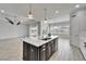 Open kitchen with an island, pendant lighting, and views of the adjacent living area and the water at 721 Manns Harbor Dr, Apollo Beach, FL 33572