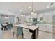 Open concept kitchen with island, stainless steel appliances, and white cabinetry at 721 Manns Harbor Dr, Apollo Beach, FL 33572