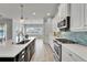 Spacious kitchen with island, stainless appliances, and view of the adjacent living space and water at 721 Manns Harbor Dr, Apollo Beach, FL 33572