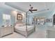 Main bedroom featuring tray ceiling, ceiling fan, and natural light from the windows at 721 Manns Harbor Dr, Apollo Beach, FL 33572