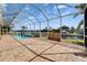 An aerial-screened in patio provides views of the pool and canal at 721 Manns Harbor Dr, Apollo Beach, FL 33572