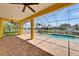 A screened-in patio includes brick flooring, and views of the pool and canal at 721 Manns Harbor Dr, Apollo Beach, FL 33572