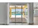 View of the pool and patio from the living room through sliding glass doors at 721 Manns Harbor Dr, Apollo Beach, FL 33572