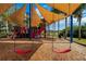 Playground with pirate ship theme, swings, and shade structure at 721 Manns Harbor Dr, Apollo Beach, FL 33572